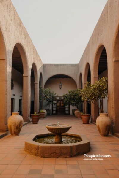 Hacienda style Mexican patio ideas with courtyard fountain and rustic adobe textures