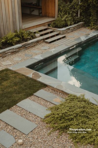 Stone accent above ground pool backyard design with natural edging and grounded modern outdoor living style