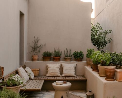 small cozy patio ideas with layered seating and warm rustic mediterranean outdoor design