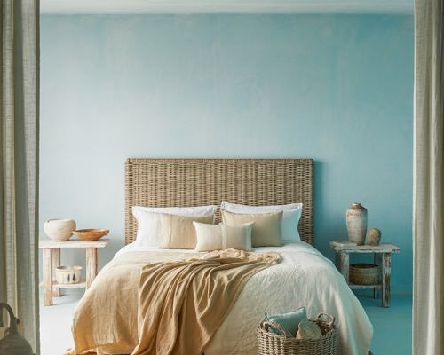 Beach theme bedroom with rattan textures linen bedding and calming coastal colors