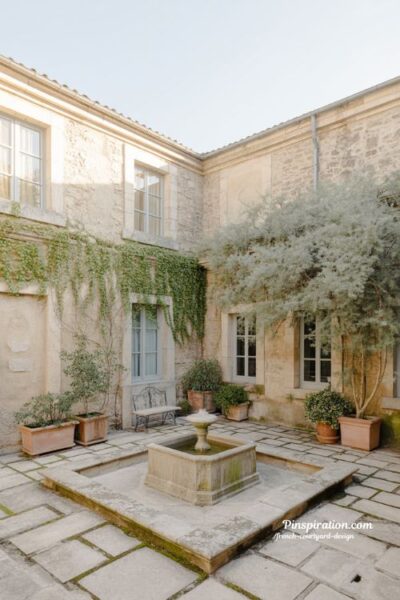 French courtyard design with timeless stone fountain and quiet private outdoor living space