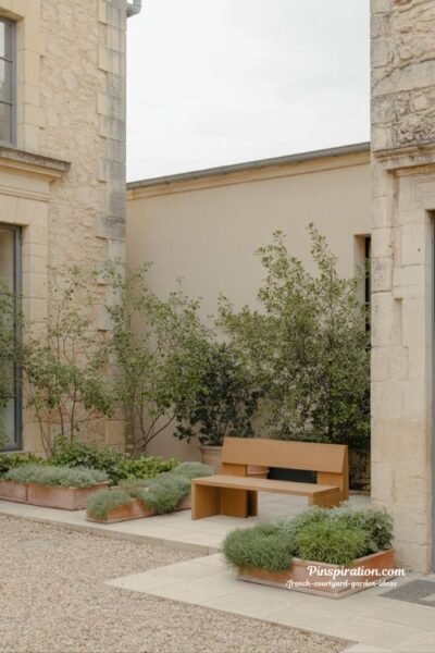 French courtyard garden ideas blending old world charm with modern minimal seating and timeless stone courtyard design