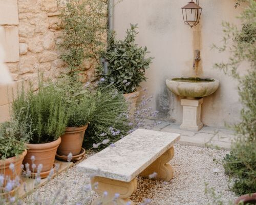 French courtyard garden ideas with lavender gravel stone bench rustic provence style courtyard