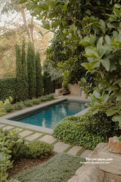 Landscaping ideas for backyard inground pool with lush greenery and natural stone design