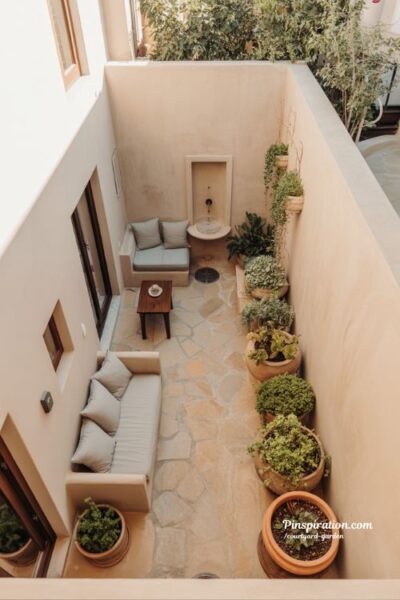 Narrow courtyard garden layout with open center space and edge planting balanced outdoor room design