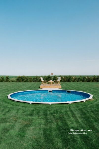 Simple lawn backyard above ground pool design with open family friendly space and minimal modern landscaping