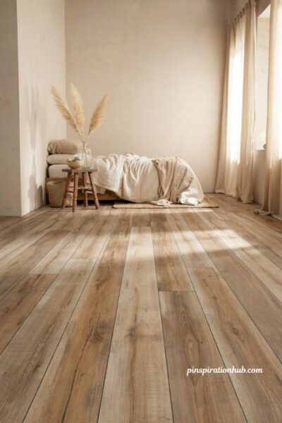 Warm driftwood luxury vinyl plank flooring ideas for a coastal bedroom