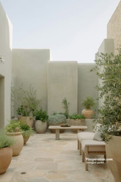 courtyard garden color palette with soft greens earthy neutrals and calm balanced outdoor design aesthetic
