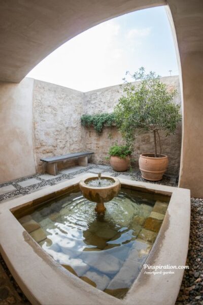courtyard garden water feature with small stone fountain and calming natural outdoor sensory design