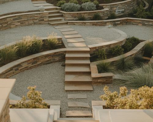 sloped backyard landscaping ideas with terraced gardens retaining walls and layered outdoor living design