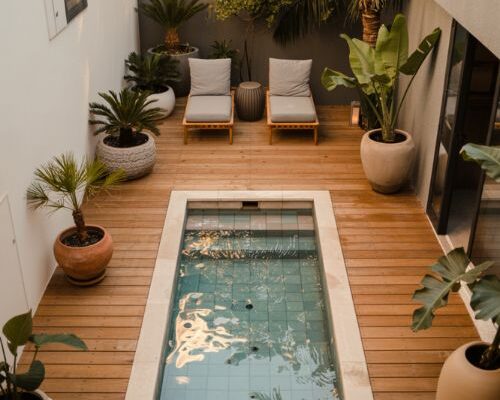 small backyard plunge pool with modern minimalist tropical patio design and cozy compact outdoor retreat