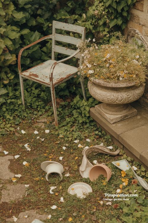 vintage garden decor ideas with rustic iron chair and wildflower stone urn aesthetic