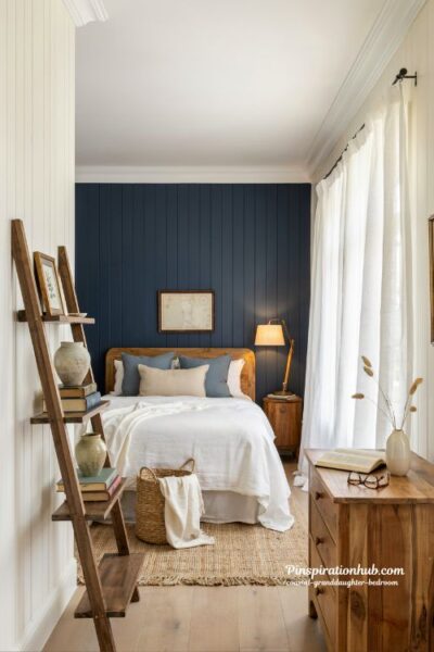 Coastal granddaughter bedroom with deep navy blue and warm natural wood decor