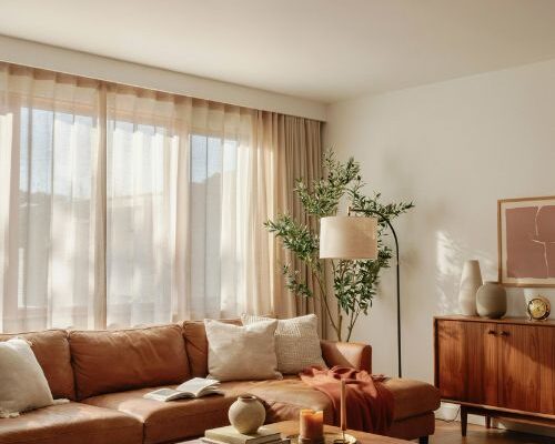 Mid century modern living room with cozy sectional sofa and warm walnut wood accents