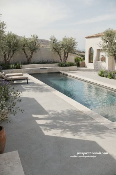 Modern Mediterranean pool with clean lines, grey concrete and olive trees Ibiza style backyard design