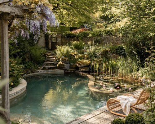 Natural pool ideas with a mountain lake inspired backyard swimming oasis