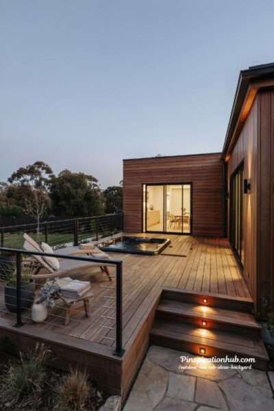 Outdoor hot tub ideas backyard with flush deck platform spa and warm cedar lighting