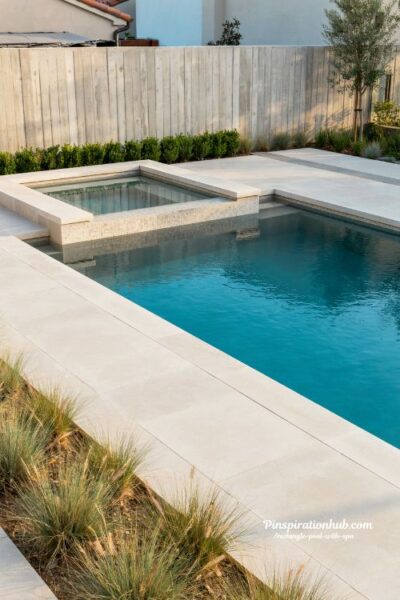 rectangle pool with integrated corner spa seamless modern backyard design with continuous water flow and minimalist luxury aesthetics