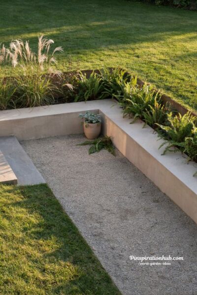sunken garden seating area with built in benches and tall ornamental grasses creating a hidden outdoor retreat