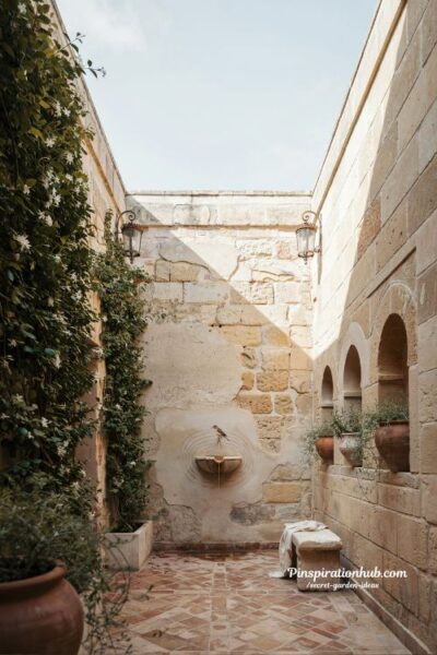 walled courtyard garden with climbing plants patterned stone floor and secret enclosed outdoor room design