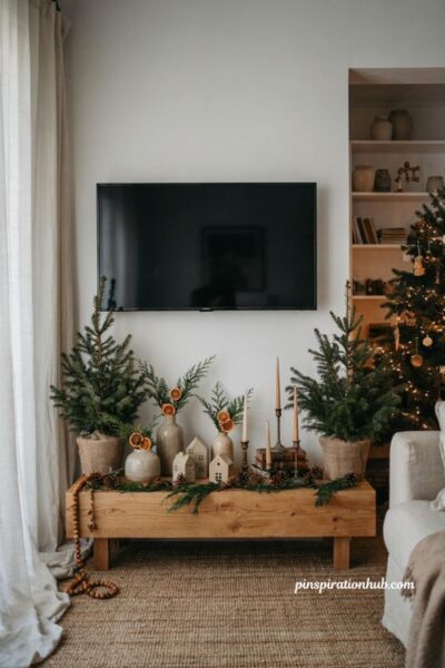 Christmas tv console decor with mirror reflection and elegant holiday living room styling