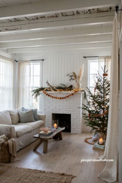 Coastal christmas living room with faux dried orange garland and natural beach house holiday decor