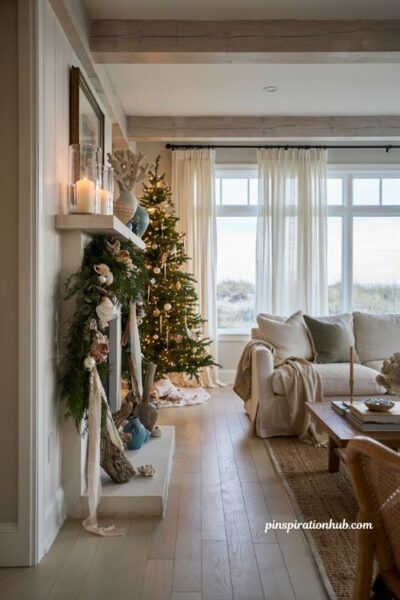 Coastal christmas mantel vignette with shell garland candles and elegant beach house holiday decor