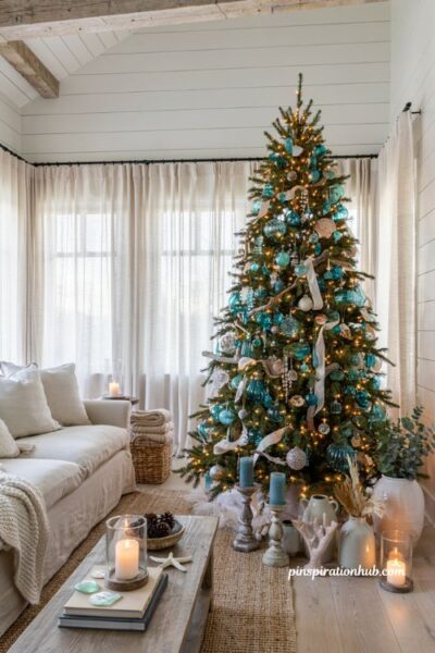 Coastal christmas tree with sea glass ornaments and elegant beach house holiday living room