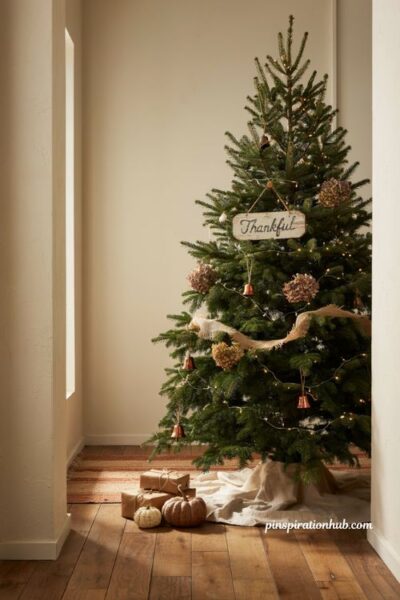 Cozy fall christmas tree with a wooden thankful sign ornament in a farmhouse entryway