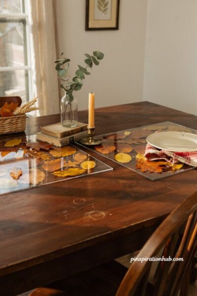 Diy laminated fresh fall leaf placemats on a rustic farmhouse dining table for autumn home decor