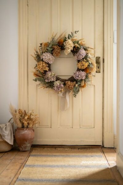Dried flower and foraged branch wreath with golden wheat on a farmhouse front door for autumn entryway decor