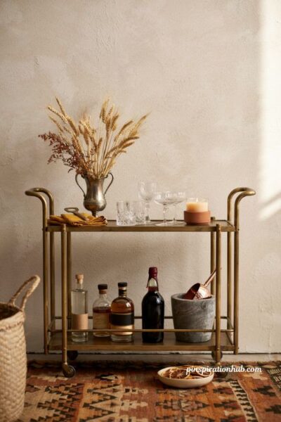Fall bar cart decor ideas with vintage brass cart dried wheat stalks crystal glassware and seasonal touches
