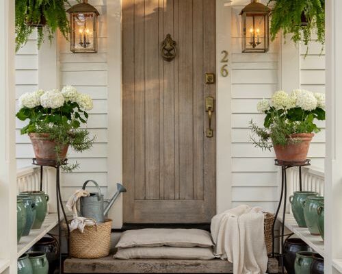 Farmhouse porch ideas with antique brass hardware and warm rustic entry styling