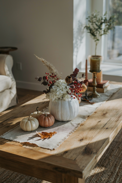 Cozy fall coffee table decor with diy craft pumpkin vase white hydrangeas and candles