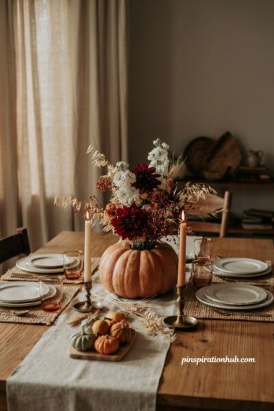 Burgundy and cream dahlia pumpkin flower centerpiece for an elegant Thanksgiving table