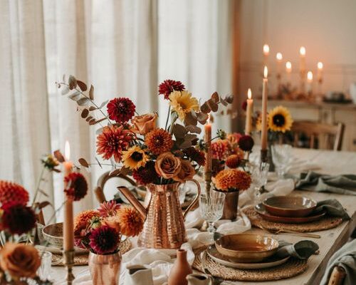 Copper centerpiece with warm fall blooms for an elegant cozy autumn dining table
