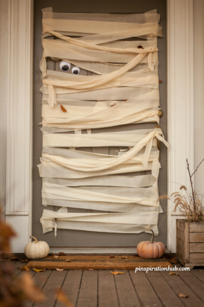 Diy mummy halloween door decoration with white gauze and googly eyes