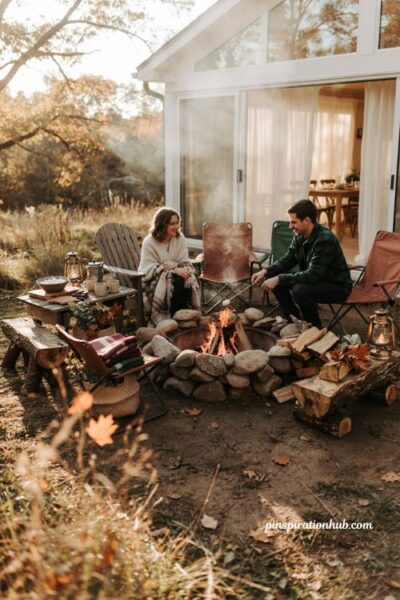 Fall sunroom baby shower bonfire with cozy blankets s'mores station and rustic seating