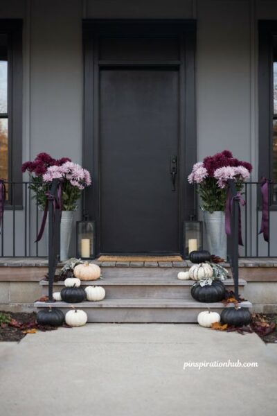 Halloween porch ideas with purple mums and black and white pumpkins