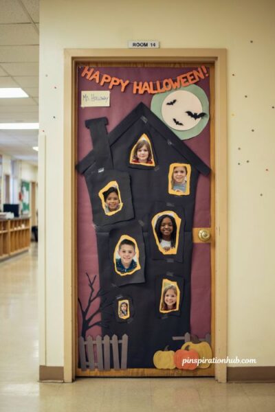 Haunted house classroom door with student photo windows for Halloween