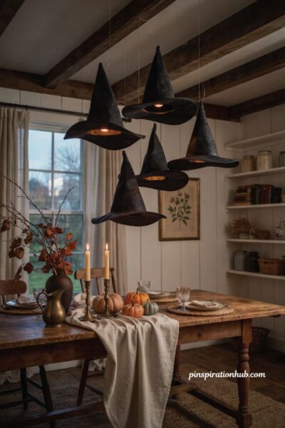 Indoor Halloween decorations with floating glowing witch hats above a cozy autumn dining table
