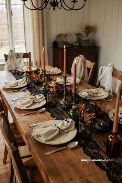 Indoor Halloween decorations with ghost napkins black lace candles and witchy dining table decor