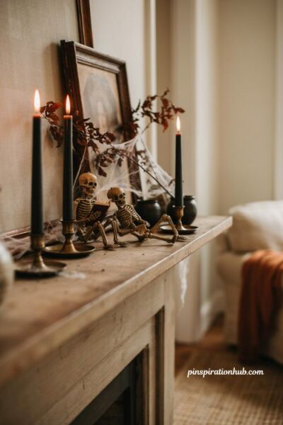 Indoor Halloween decorations with playful light up skeletons black candles and cobweb mantel decor