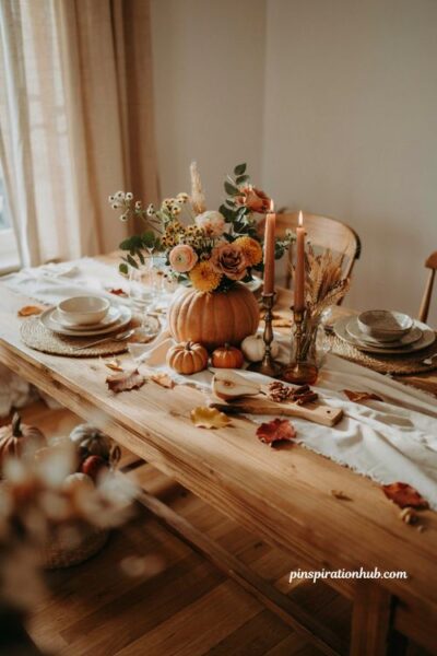Pumpkin flower centerpiece idea with fall blooms for a cozy farmhouse dining table
