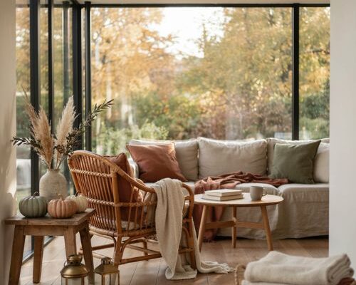 fall sunroom decor with burgundy forest green and rust pillows for a cozy autumn look
