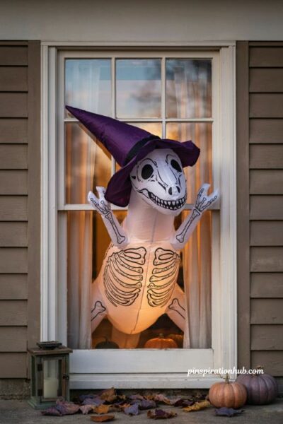 inflatable Halloween window decorations with skeleton dinosaur, witch hat, glowing window and pumpkins