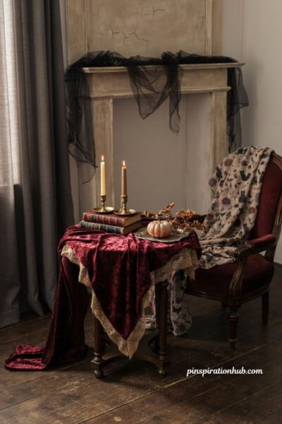 vintage Halloween burgundy and black textiles with velvet, lace, gauze, old books and gothic living room decor