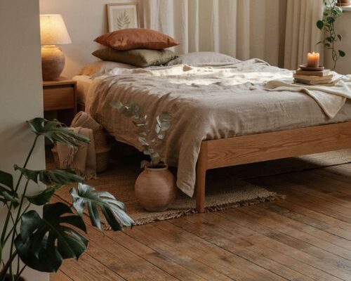 Earthy cozy bedroom with natural wood linen clay and greenery
