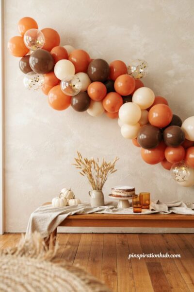 Fall balloon garland with clear balloons filled with gold confetti