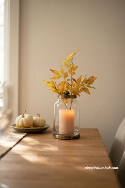 Fall centerpiece ideas with a yellow foliage hurricane lantern